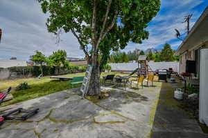 View of patio with a playground