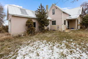 View of snow covered rear of property