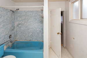 Bathroom with tile patterned flooring and shower / bathing tub combination