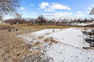 Snowy yard with a mountain view