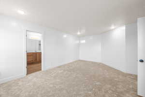 Spare room with light carpet and baseboards