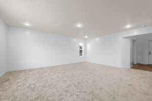 Empty room featuring baseboards and light colored carpet