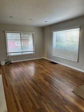 Unfurnished room featuring dark wood-type flooring