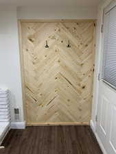 Details with hardwood / wood-style flooring and crown molding