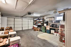 Garage featuring a garage door opener and ceiling fan