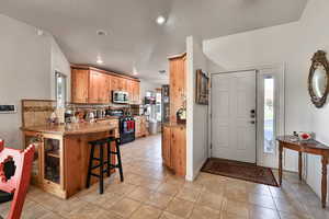 Entrance foyer featuring sink, a textured ceiling, and light tile patterned floors