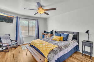 Bedroom with wood-type flooring and ceiling fan