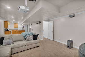 Carpeted living room with ornamental molding