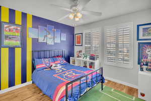 Bedroom featuring hardwood / wood-style flooring and ceiling fan