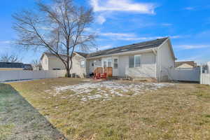 Rear view of property featuring a lawn