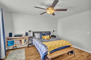 Bedroom featuring ceiling fan and light hardwood / wood-style flooring