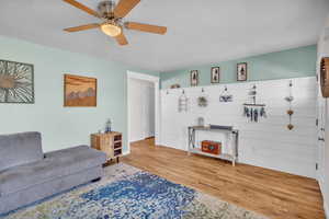 Living room featuring hardwood / wood-style floors and ceiling fan