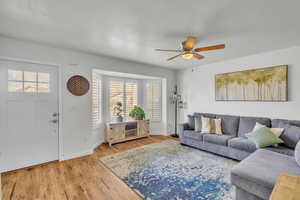 Living room featuring hardwood / wood-style floors and ceiling fan