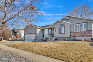 Ranch-style house with a garage and a front yard