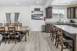 Kitchen featuring quartz countertops, stainless steel appliances, beautiful upgraded cabinets, with a center island