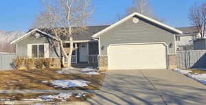 View of front of property with a mountain view and a garage