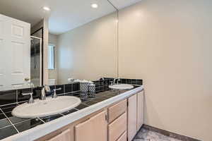 Bathroom with walk in shower, vanity, and toilet