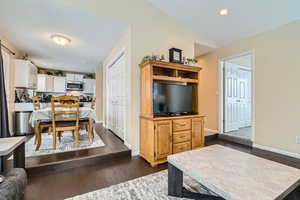 Living room featuring dark hardwood / wood-style floors and vaulted ceiling