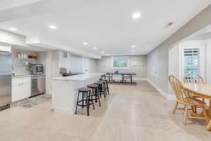 Large basement kitchen with stainless appliances