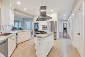 Custom kitchen with white cabinetry and stainless steel appliances