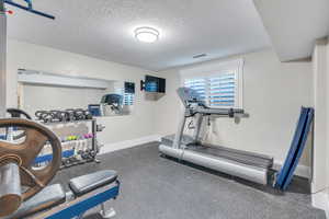 Workout room featuring a textured ceiling