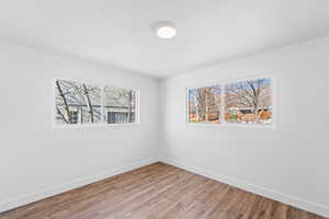 Unfurnished room with hardwood / wood-style flooring