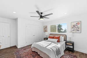 Bedroom featuring ceiling fan, dark hardwood / wood-style flooring, and a closet