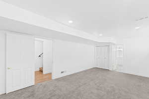 Bonus room with light colored carpet