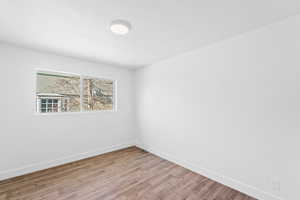 Unfurnished room featuring hardwood / wood-style flooring