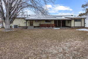 Rear view of house featuring a patio and central AC