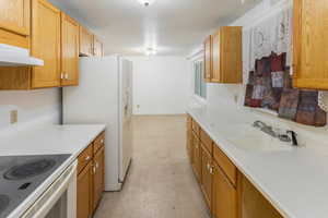 Kitchen with sink and white appliances