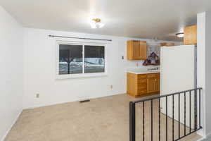 Kitchen featuring white refrigerator