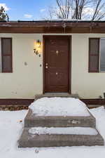 View of snow covered property entrance