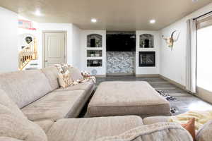 Living room featuring hardwood / wood-style floors and built in features