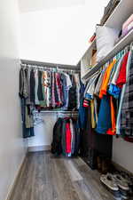 Spacious closet with hardwood / wood-style floors