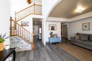 Living room with dark wood-type flooring and a textured ceiling