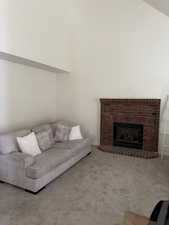 Living room featuring carpet and a fireplace