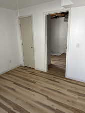 Unfurnished room with baseboards and light wood-style floors