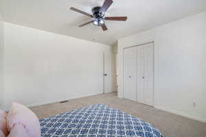 Bedroom featuring visible vents, baseboards, and light colored carpet