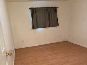 Spare room featuring light hardwood / wood-style flooring and a textured ceiling