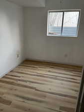 Unfurnished room featuring baseboards and wood finished floors