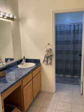 Bathroom with vanity and tile patterned floors