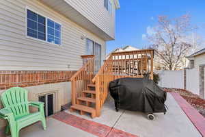 View of patio / terrace with area for grilling, stairs, and fence