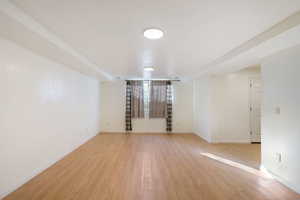 Spare room with baseboards and light wood-style flooring