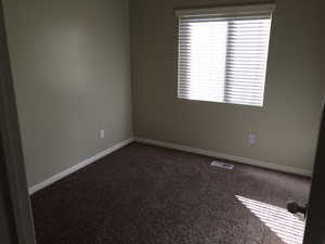 Spare room featuring carpet