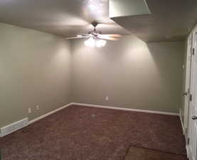 Empty room with ceiling fan and carpet