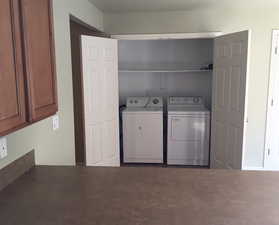 Laundry area featuring washing machine and clothes dryer