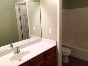 Full bathroom with vanity, bathtub / shower combination, tile patterned floors, and toilet