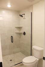 Bathroom with a shower with door and toilet