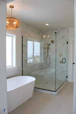 Bathroom with tile patterned floors and separate shower and tub